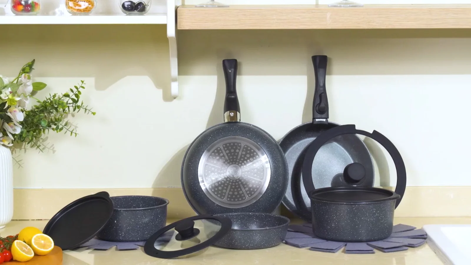The whole set on one shelf: bodies nested, handles clicked off, lids on top.