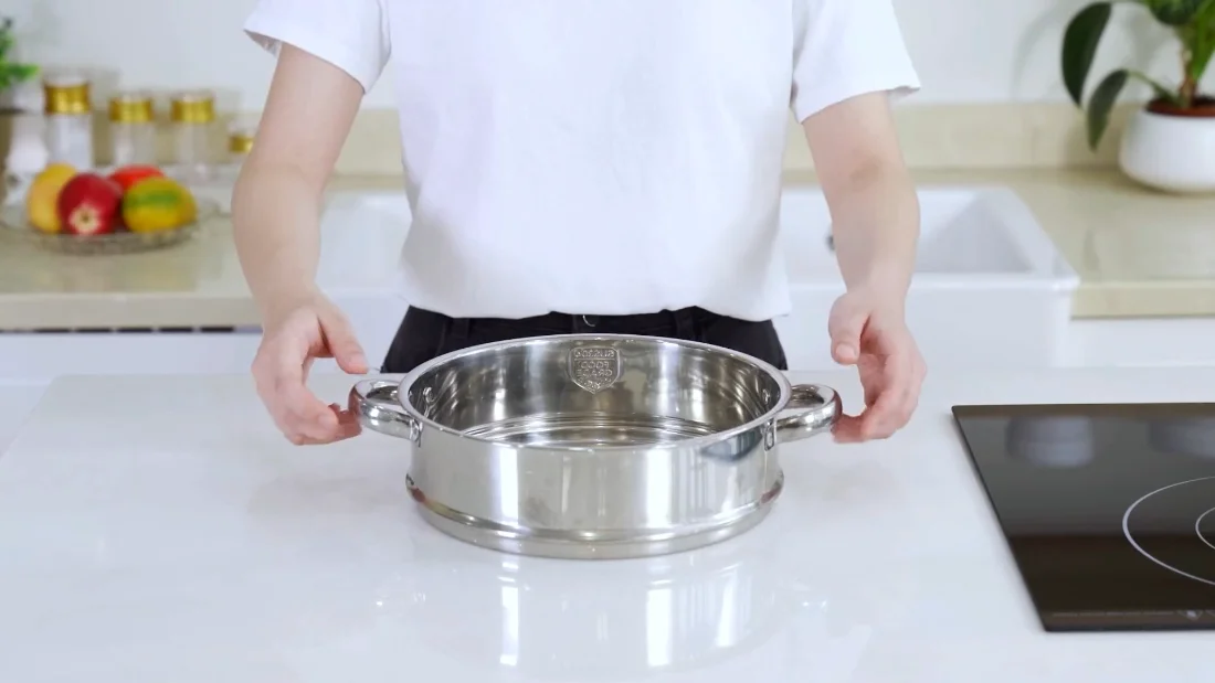 The steamer insert is stainless on purpose: it boils hard so the coated pots do not have to.