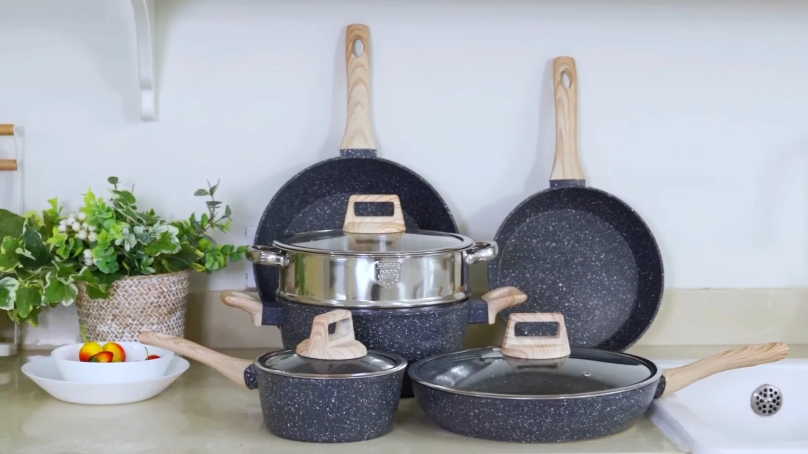 The SODAY granite cookware set arranged on a cream kitchen counter